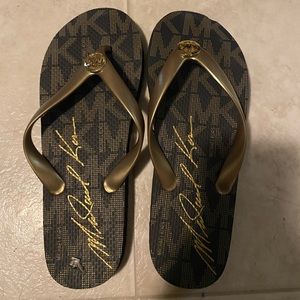 brown and gold mk flip flops